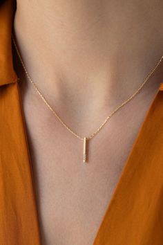 Our Solid Gold Diamond Vertical Bar Necklace is perfect for all classic lovers. It is indispensable for your jewelry box as it is magnificent and elegant. FEATURES * Made to order. * Gold KT: 14K * Gold Color Selection: Yellow Gold, Rose Gold, White Gold * Diamond Quality: Diamond carat: 0.02 ct. Cut: Perfect cut Diamond type: Zircon Setting Type: Prong Setting * Pendant Lamp Height: 15 mm / 0.59 inch * Pendant Width: 1 mm / 0.03 inch * Length: 14", 16", 18", 20" * Ready to Ship in 1-3 Business Luxury Yellow Gold Bar Necklace For Women, Elegant Rose Gold Bar Necklace For Gift, Elegant Rose Gold Bar Necklace Gift, Elegant Diamond Bar Necklace In Yellow Gold, Elegant Bar Necklace With Cable Chain, Elegant Yellow Gold Diamond Bar Necklace, Elegant Everyday Bar Necklace With Cable Chain, Elegant 14k Gold Bar Necklace With Rectangular Pendant, Elegant 14k Gold Bar Necklace With Cable Chain