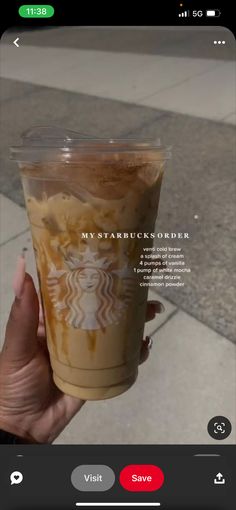 someone holding up a cup of coffee on their cell phone with the caption, my starbucks