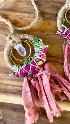 two pieces of rope hanging from the side of a wooden table with flowers on it