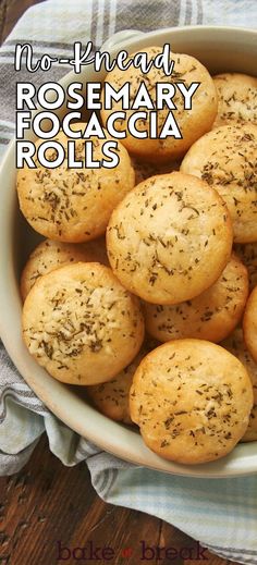 a white bowl filled with rosemary focaccia rolls