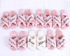 several pairs of pink slippers with names on them