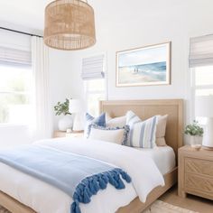 a bed with blue and white pillows in a bedroom