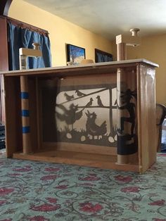 an open book shelf with some artwork on it