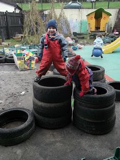 two children playing with tires on the ground