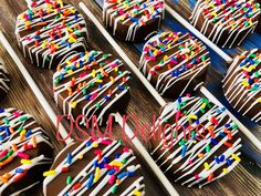 chocolate covered cookies with sprinkles on wooden sticks