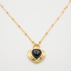 The perfect accessory for any look, the Luna Black Onyx Necklace features a natural black onyx stone in a love heart shape. Crafted with a chain necklace, the piece is easy to style and wear daily. To keep your jewellery in the best condition, we recommend giving it a good care over time. By using a soft, lint-free jewellery cloth, you can remove blemishes that result from body oils, perfumes and lotions. Also remember try not to expose your jewellery in the open air. Our branded dusty bag or yo Black Heart Pendant Necklace With Clavicle Chain, Gift Black Charm Necklace With Chain, Black Clavicle Chain Necklace For Valentine's Day, Black Chain Necklace For Valentine's Day, Valentine's Day Black Clavicle Chain Necklace, Black Valentine's Day Necklace, Valentine's Day Black Chain Necklace, Black Pendant Necklaces With Heart Charm, Black Pendant Necklace With Heart Charm