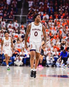 an auburn basketball player walking on the court