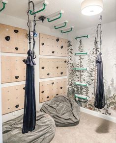 a room that has some kind of climbing equipment on the wall and hanging from hooks