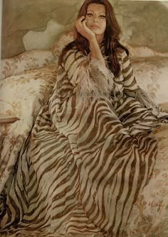 a painting of a woman sitting on top of a bed in a zebra print blanket