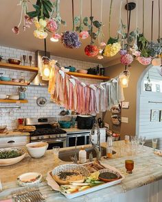 a kitchen filled with lots of food and hanging lights