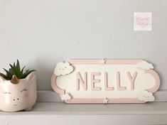 there is a small potted plant next to a sign that says nely on it