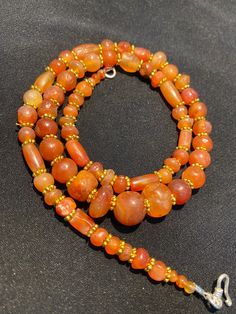 The orange color carnelian beads from my collections of ancient Himalayan antique beads The origin of this beads from Tibet Himalaya although the carnelian agate can be found in Nepal Pakistan India Nepal and Afghanistan as well carnelian agate was used as prayers beads in mala and used as jewelry and amulet as well old agate and carnelian was used as trade items as well in ancient times The age of this beads are more than 1000 years some gold color brass beads are used as spacers best gift for Orange Gemstone Beads For Jewelry Making, Handmade Antique Amber Beaded Necklace, Orange Round Beads Jewelry For Rituals, Antique Handmade Amber Beaded Necklace, Antique Handmade Amber Beaded Necklaces, Traditional Orange Gemstone Bead Necklaces, Bohemian Orange Carnelian Beaded Necklaces, Traditional Orange Gemstone Beads Necklace, Traditional Orange Beaded Necklace With Oval Beads