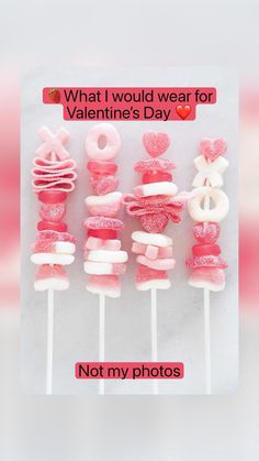 pink and white lollipops are arranged on top of each other in the shape of hearts