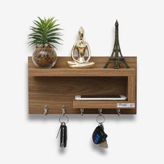 a wooden shelf with key holders and keys