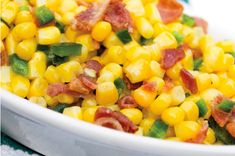 a white bowl filled with corn and bacon