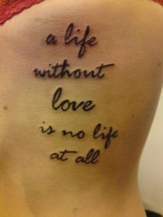 a woman with a tattoo on her back saying, a life without love is no life at all