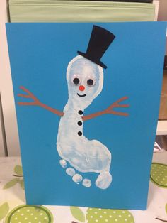 a card with a snowman painted on it