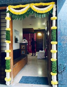 an entrance decorated with yellow and white flowers