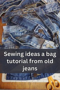 a pile of jeans sitting on top of a wooden floor next to scissors and measuring tape