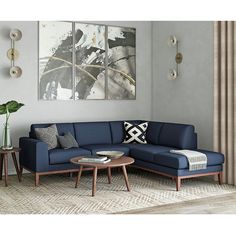 a living room scene with focus on the sectional sofa and coffee table in the foreground