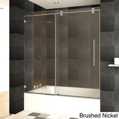 a bathroom with black and white tiles on the walls