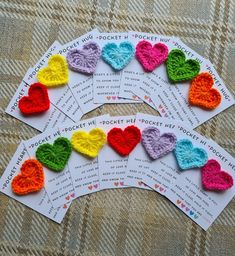 six crocheted hearts are arranged on top of each other in different colors and sizes