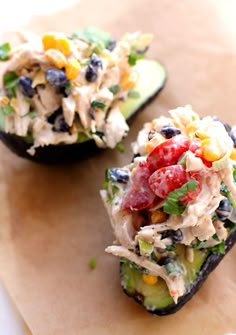 two stuffed avocados with tuna salad on them