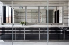 a large bathroom with mirrors and sinks in the middle of it's wall to wall walls