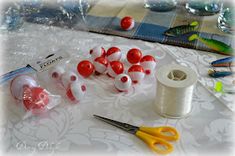 some crafting supplies are on a table with scissors and spools of thread