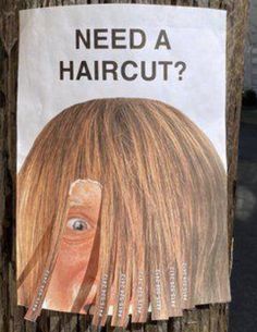 a sign on a telephone pole that says, need a haircut? with an image of a woman's head