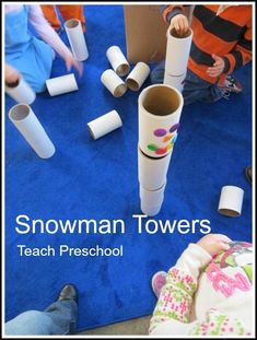 children playing with snowman towers made out of toilet paper rolls and cardboard tubes on the floor