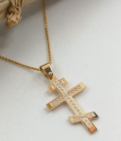 "A fine quality cross in 14K with yellow and white solid gold. It's decorated with 29 pieces of Swarovski stones!(it can also be set with REAL DIAMONDS ) A beautiful cross. Ideal for a present, engagement gift and baptism. ✪ Please check the dimensions to be sure about the size! Cross Pendant Dimensions: Height - 1.18 inches / 3 cm Width - 0,78 inches / 2 cm Thickness - 0,032 inches / 0,80 mm The chain is NOT included in the price. To see the inches and prices of the chains, please click on the Gold Cubic Zirconia Cross Necklace, Yellow Gold Cubic Zirconia Cross Necklace, Godmother Necklace, Cross Christian, Princess Necklace, Beautiful Cross, Gold Cross Necklace, Gold Name Necklace, Swarovski Stones