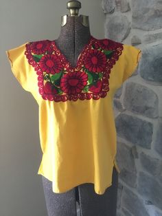 "This cute summer top is homemade and embroidered.  It is in great condition and would be a nice addition to your wardrobe, for almost any occasion.  Size could vary depending on how you like your clothes to fit.  It is a box style - so if you like your clothes to fit looser, and your'e a size small, this would work. Could also be worn as a cute cropped shirt with a waste banded added or bottom removed.  Size - Small Armpit to Armpit - 21\" Length Shoulder to Bottom - 23\"" Summer Crew Neck Tops With Floral Embroidery, Cute Floral Embroidery Summer Tops, Cotton Crew Neck Beach Blouse, Yellow Embroidered Short Sleeve Top For Spring, Crew Neck Cotton Blouse For Beach, Red Crew Neck Top With Machine Embroidery, Crew Neck Cotton Blouse For The Beach, Summer Red Tops With Embroidered Neckline, Cute Multicolor Embroidered Tops For Spring