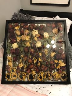 flowers in a shadow box with the caption i've kept all the flowers my boyfriend has given me once went into a box and i finally put them into a huge shadow box