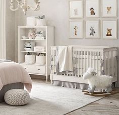 a baby's room with white furniture and pictures on the wall