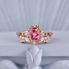 a close up view of a pink ring with diamonds