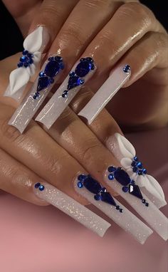 Acrylic Nails Blue Rhinestones, Mail Ideas With Diamonds, Long Nail Designs Stilettos Bling, White Nails With Blue Gems, Long Blue Acrylic Nails With Rhinestones, Blue Nails Quinceanera, White Nails With Blue Rhinestones, Blue Nail Designs With Rhinestones