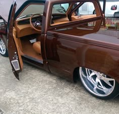 a brown pickup truck with its door open