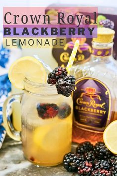 a glass filled with lemonade and berries next to bottles