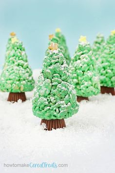 small christmas trees made out of green frosting in the snow with gold stars on top