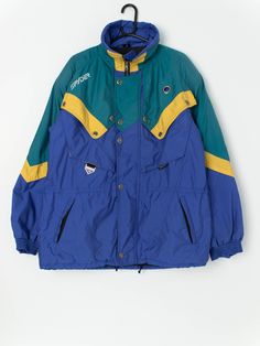 Vintage Spyder men's ski jacket in blue, green and yellow. The jacket features two hand pockets with zip closure, zips underneath both armpits (to allow you to adjust the air flow!) and a drawstring hem. This jacket will be perfect for the cold months with its Thinsulate polyester insulation. Made from a soft, light to mid-weight material. Made in  Poland.  Our recommended size: Medium  Label says: EUR - 52. USA - Large  Condition: Very good, small mark on the back and left shoulder (see last im Ski Vintage, Spyder Men, Ski Jacket Mens, Green And Yellow, Ski Jacket, Soft Light, Raglan Sleeve, Mens Jackets, Blue Green