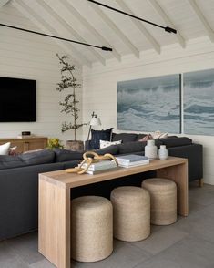 a living room filled with furniture and a flat screen tv mounted to the side of a wall