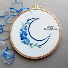 a blue flowered embroidered on a white hoop