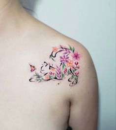 a woman's shoulder with flowers and butterflies on the left side of her body