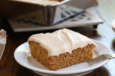 a piece of cake sitting on top of a white plate next to a knife and fork