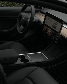 the interior of a car with an ipad on the dashboard