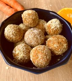 a blue bowl filled with carrots and balls of food