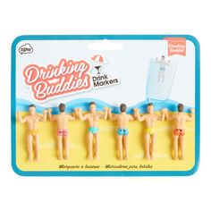 three plastic toy figures of men in bathing suits on the beach