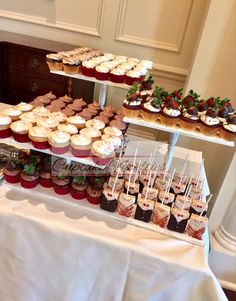 desserts and cupcakes are displayed on three tiered trays