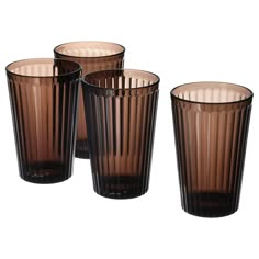 four brown glass cups sitting next to each other